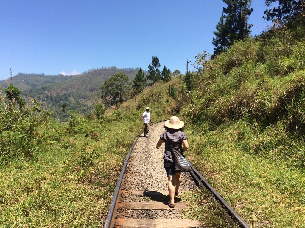 Teresa is walking an old train rail in the mountains of Sri Lanka.